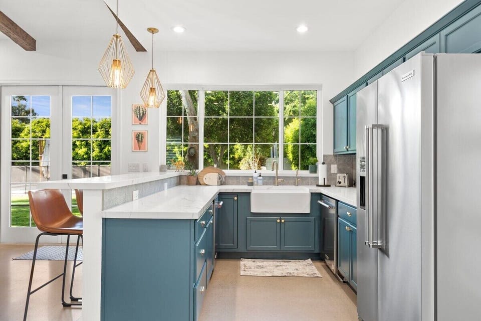 Quartz countertops with high top seating area and stainless steel appliances
