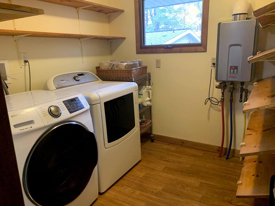 Laundry room with instant water heater