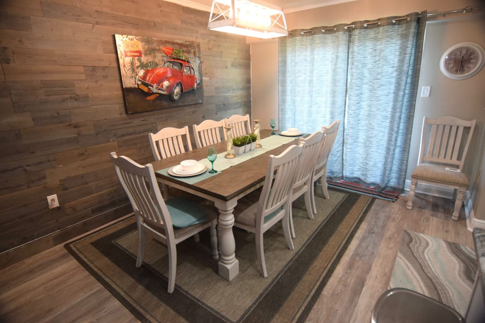 Dining table seats 8 guests with the sunset deck just beyond