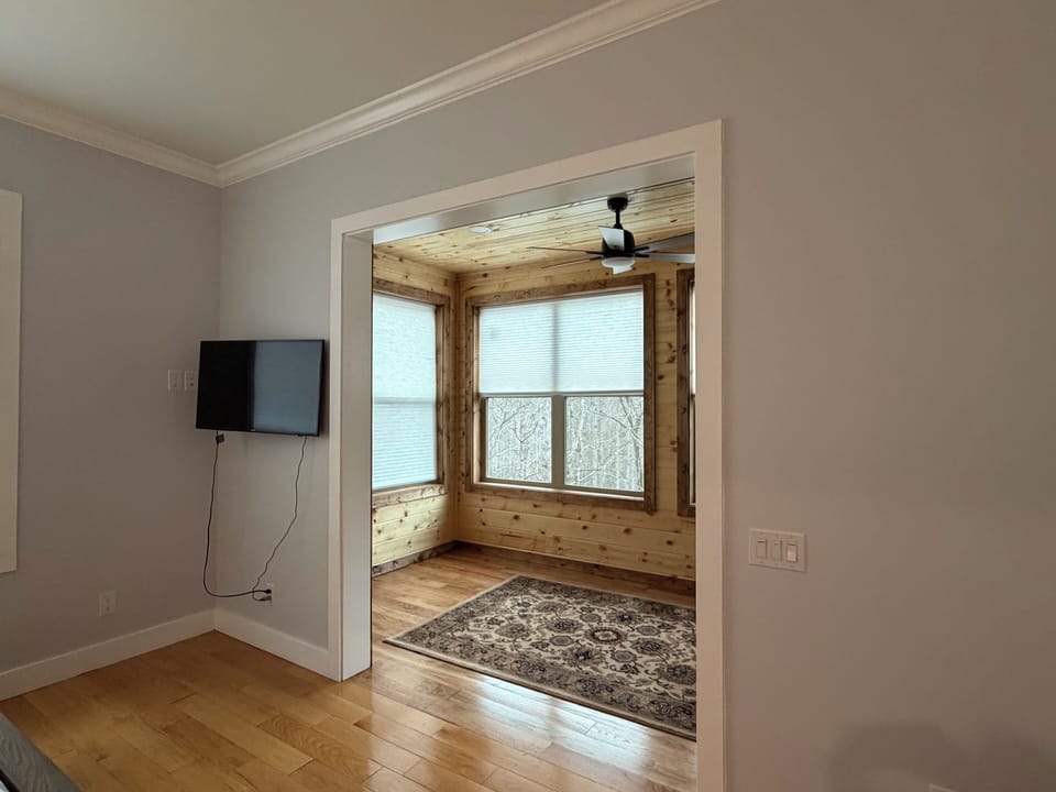 View from remodeled Master Bedroom to finished sun room  w/fan  (March 2026)