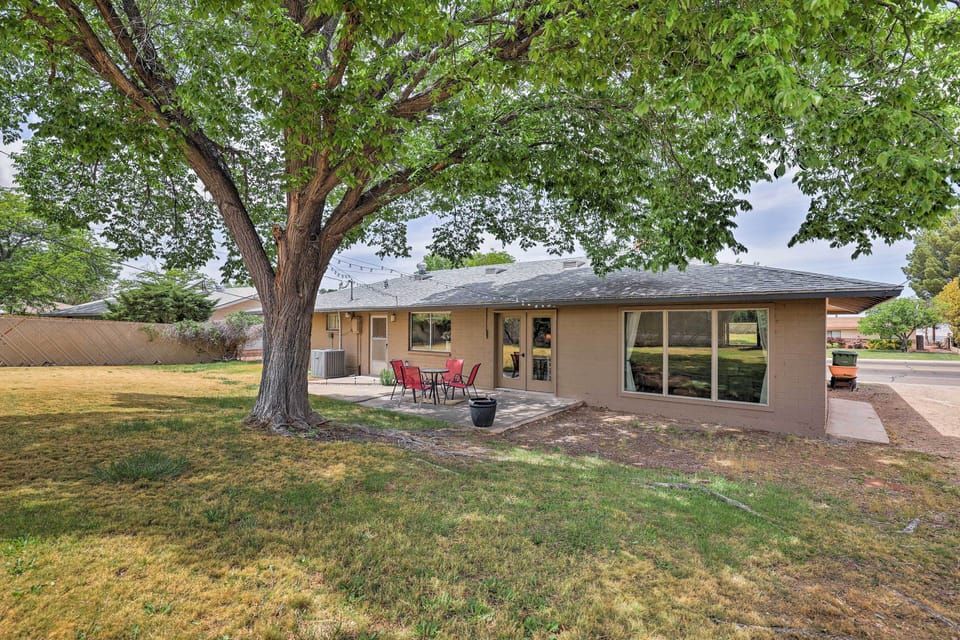 Fenced, private backyard with large shade tree