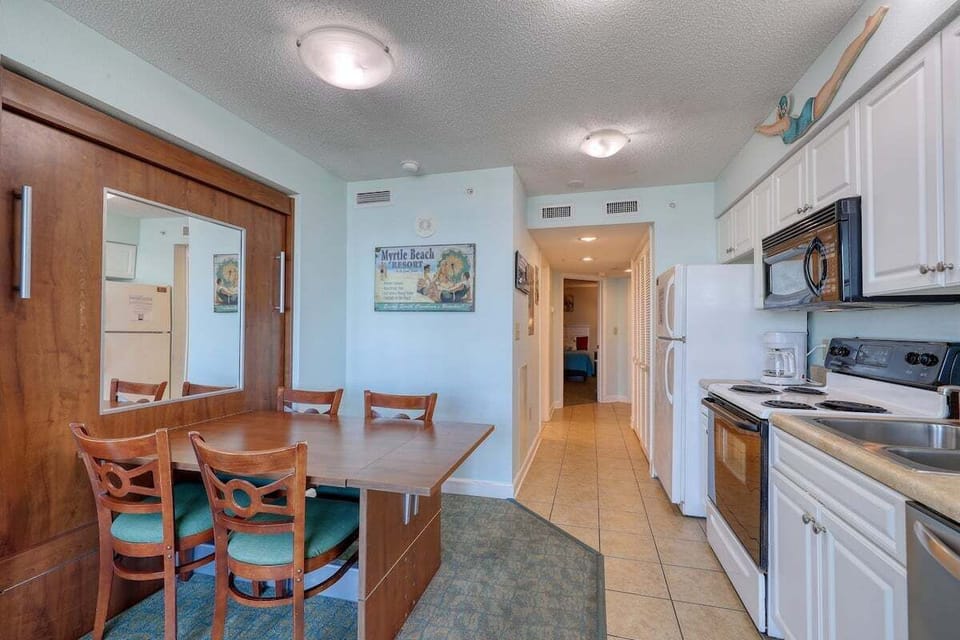Dining Area: Enjoy meals at this inviting table, perfect for gatherings and beachside memories!