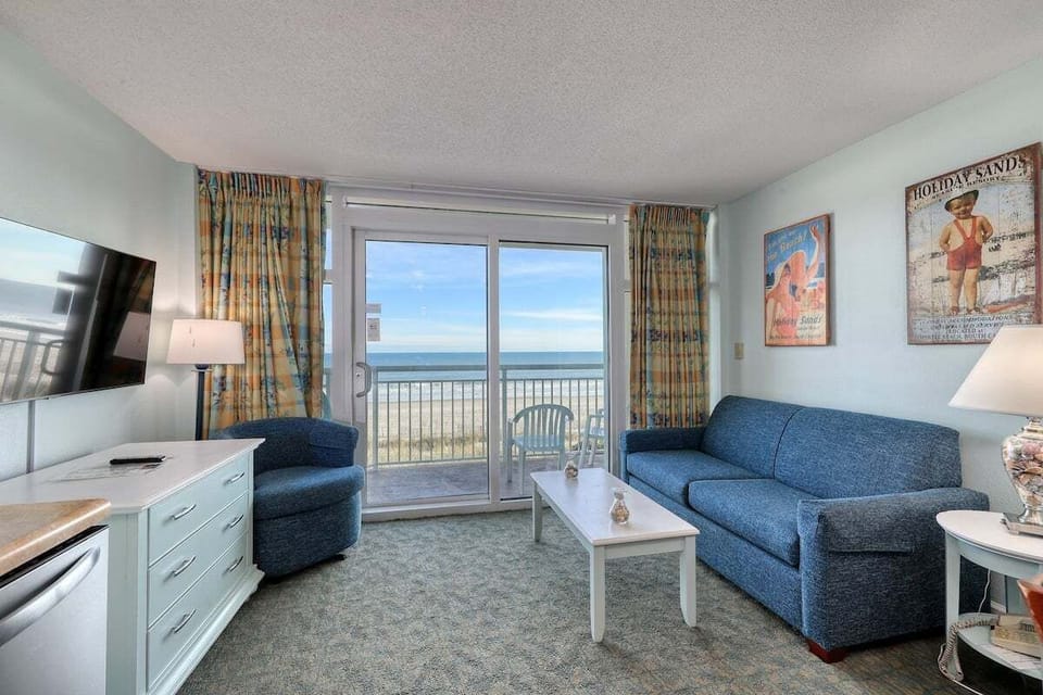 Living Room: Bright space with ocean views and charming beach decor for your perfect getaway!