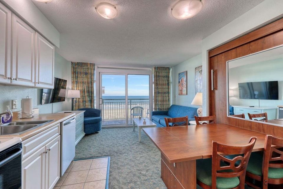 Living Room: Bright and airy space with ocean views, perfect for relaxing or game nights!