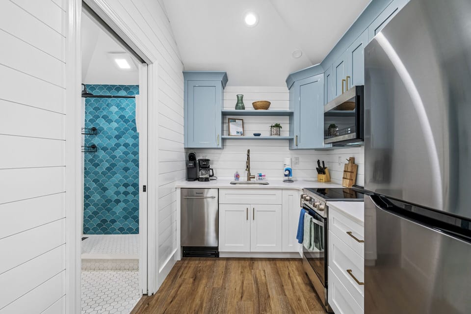 Sleek kitchen with modern fixtures and ample lighting.