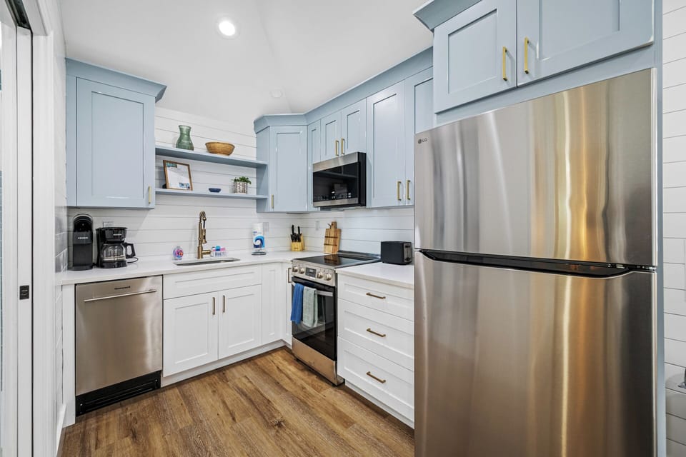 Fully equipped kitchen with stainless steel appliances.