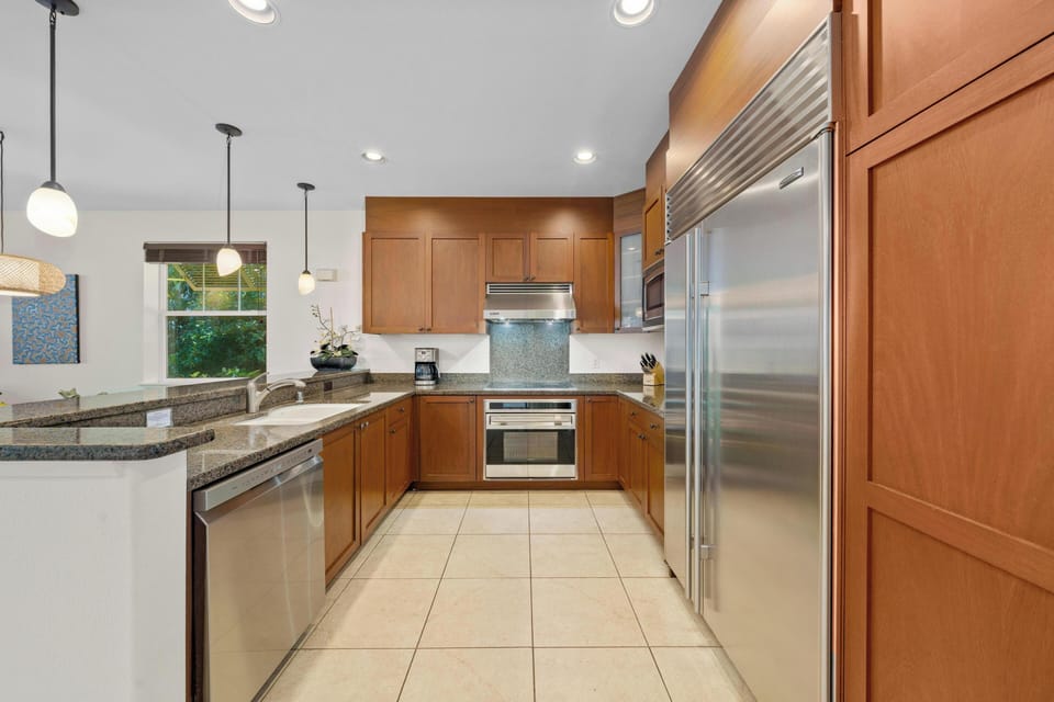 Your gourmet kitchen features granite counters, stainless steel appliances, and warm wood cabinets—perfect for crafting memorable meals during your stay.