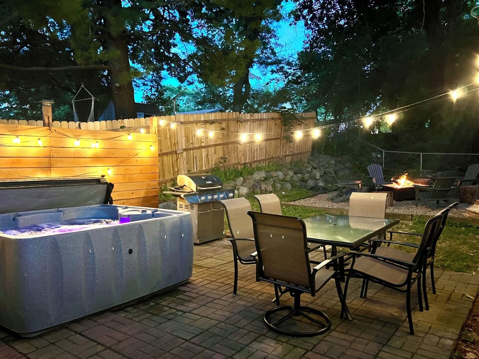Secluded outdoor fire pit space. Patio with grill and 6 person hot tub. 