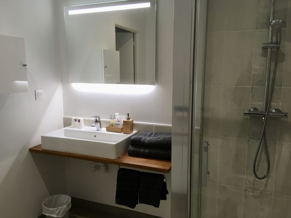 Shower, rainfall showerhead, hair dryer, towels