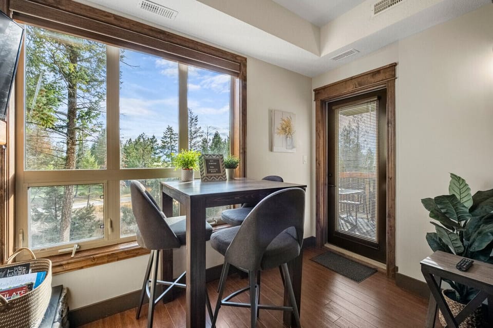 Dining area with seating for 3 at the table, and 3 at the kitchen island.