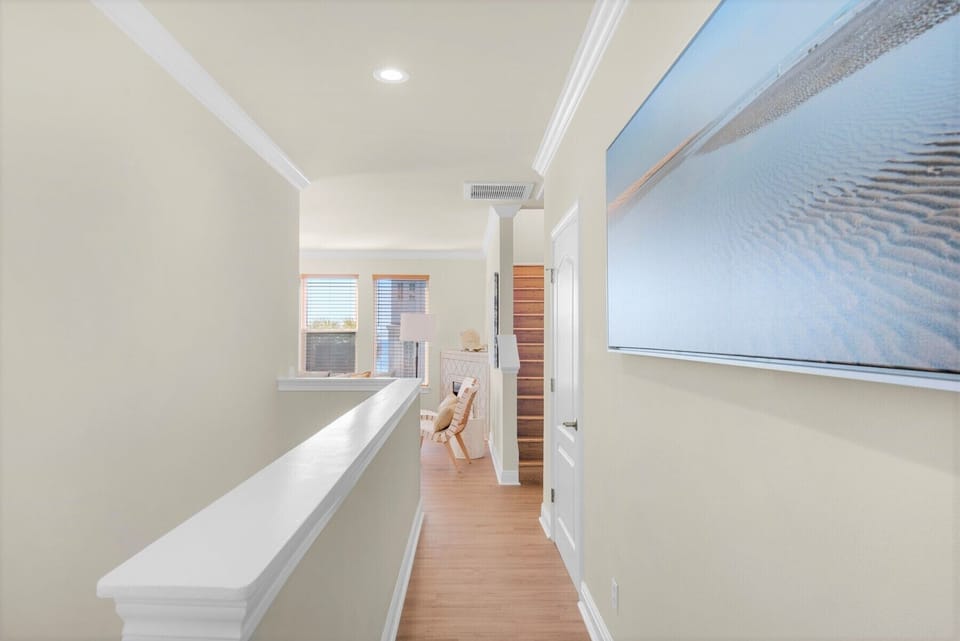 2nd floor.  Hall corridor flowing to ocean view living room and balcony.