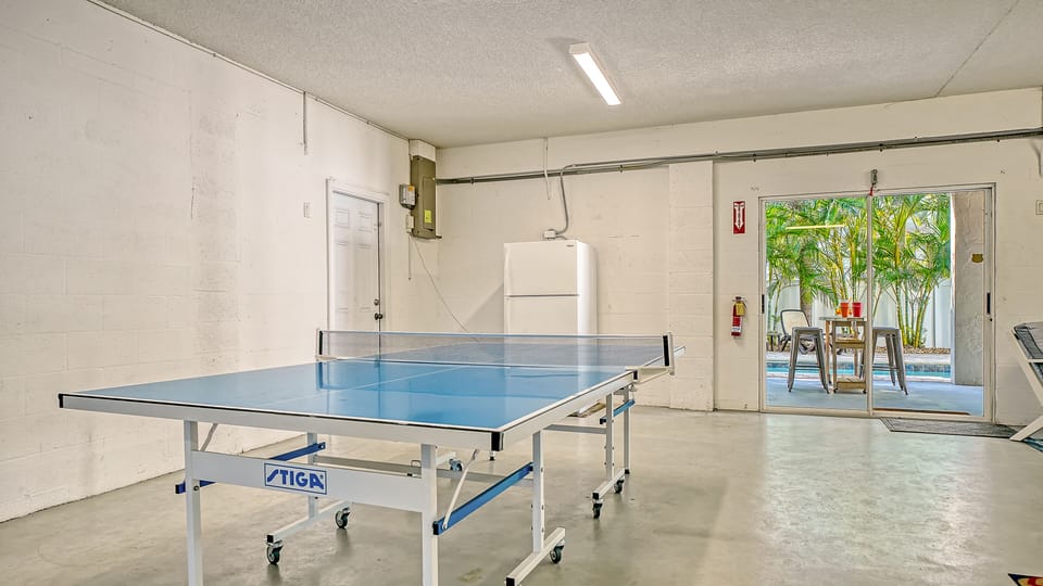 Cabana room right off the pool with ping pong and cornhole — where friendly competitions happen daily.