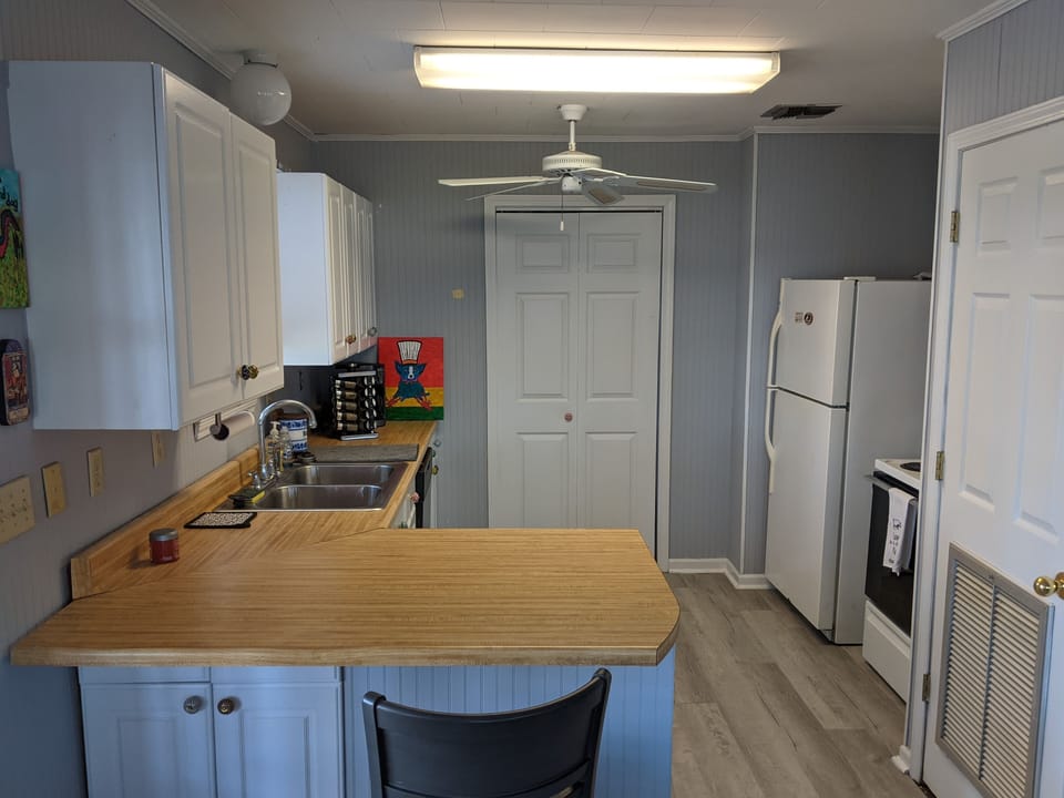 Beyond kitchen is pantry door. Lots of room for grocery storage, ice chest, etc 