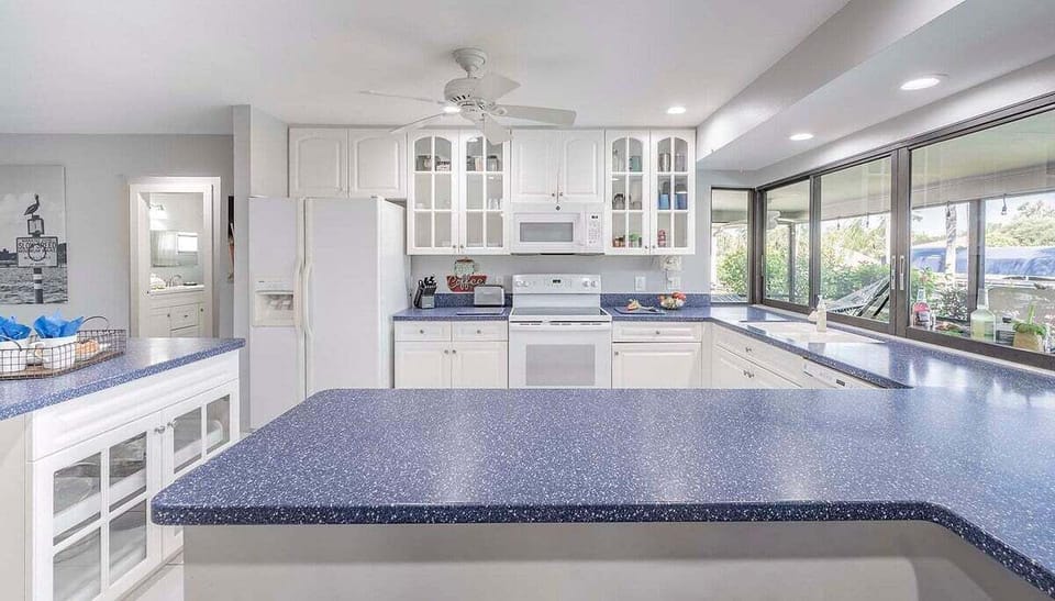 Kitchen with Windows that Open Up to Pool and Lanai