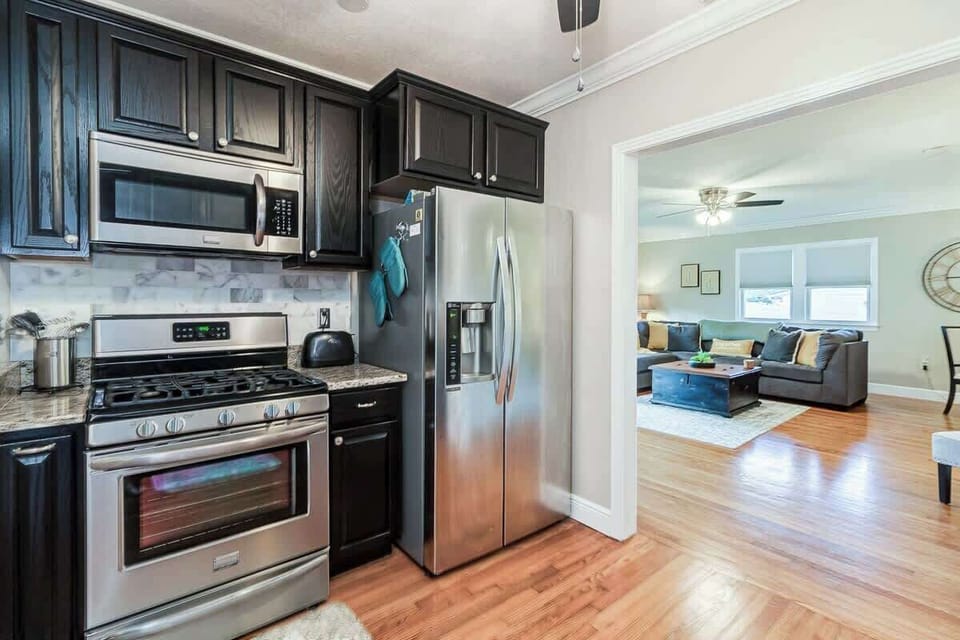 This full-size apartment kitchen features a gas stove and oven, fridge, dishwasher, microwave, toaster, and is fully stocked with spices and all essentials. It has everything you need for cooking, making it perfect for any culinary adventure.