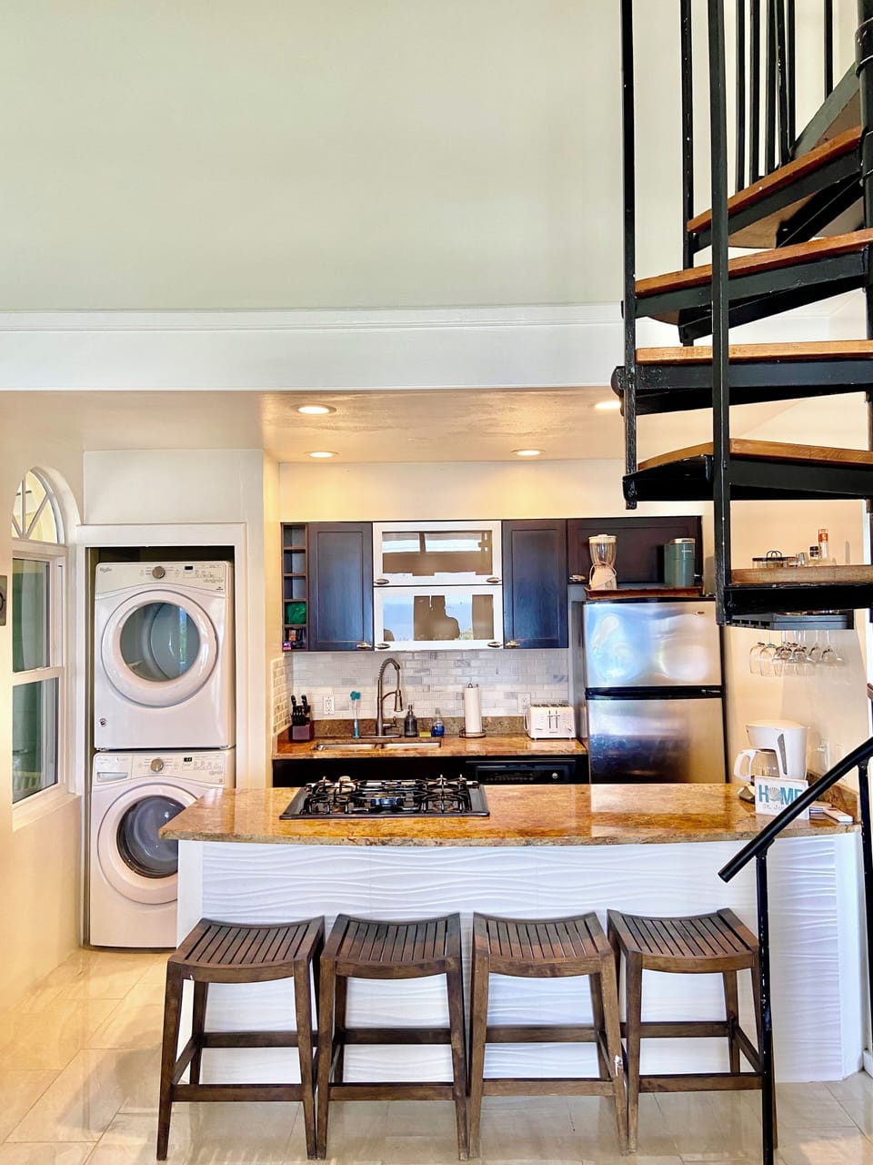 Kitchen has traditional coffee pot, Keurig pod,  blender, wine glasses & spices.