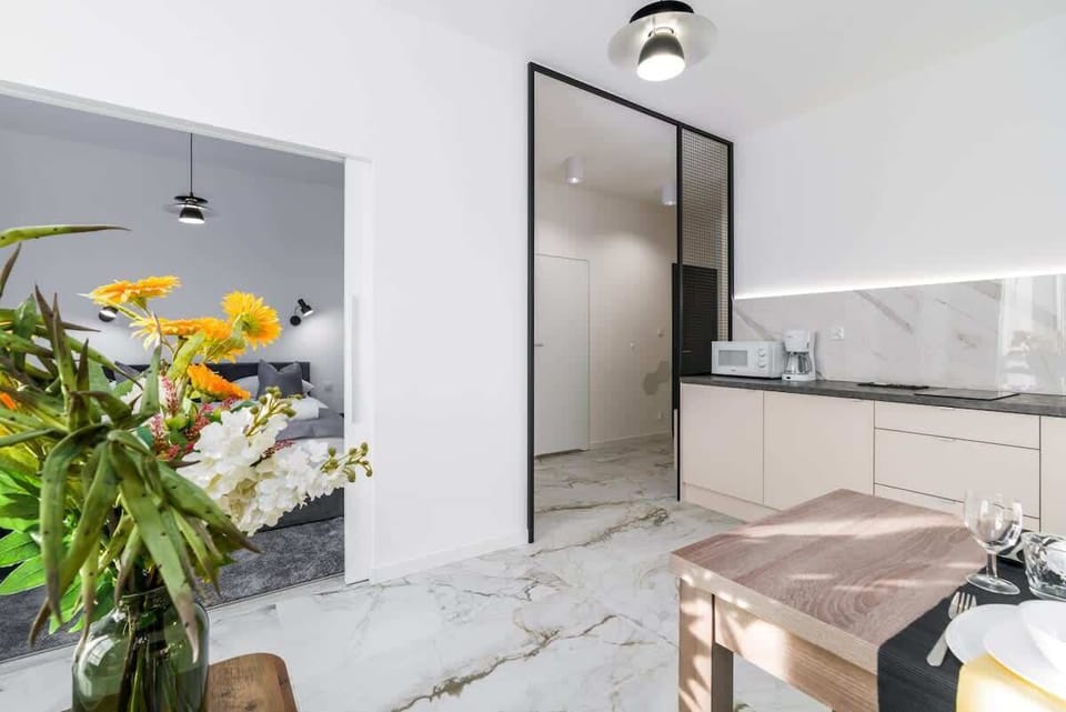 Kitchenette with kettle and refrigerator. 