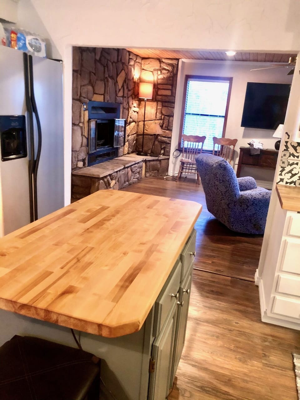 Kitchen view into liv room and fireplace.  TV can be viewed from kitchen as well