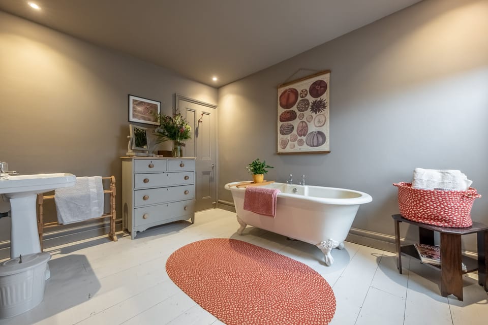 First floor: Master en-suite with roll top bath