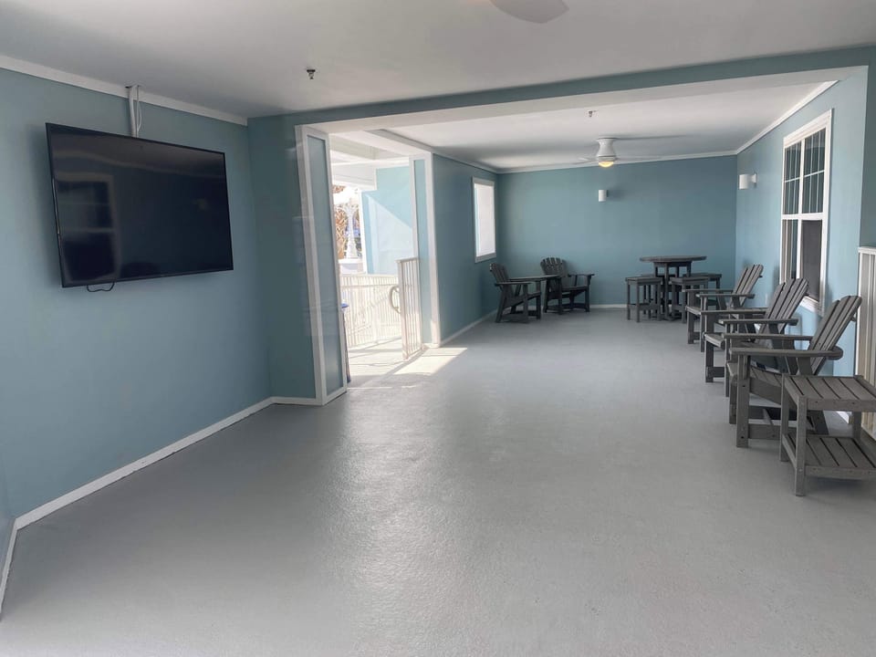 large screen TV in the breezeway near the pool