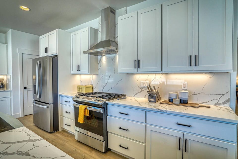 Stainless Steel Kitchen and marble counters. This open floor plan leads you to the lakefront hot tub.