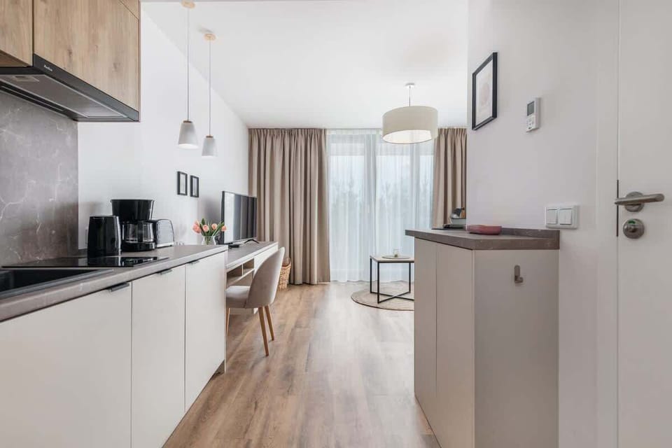 Kitchenette with plenty of kitchen utensils and dishes. 