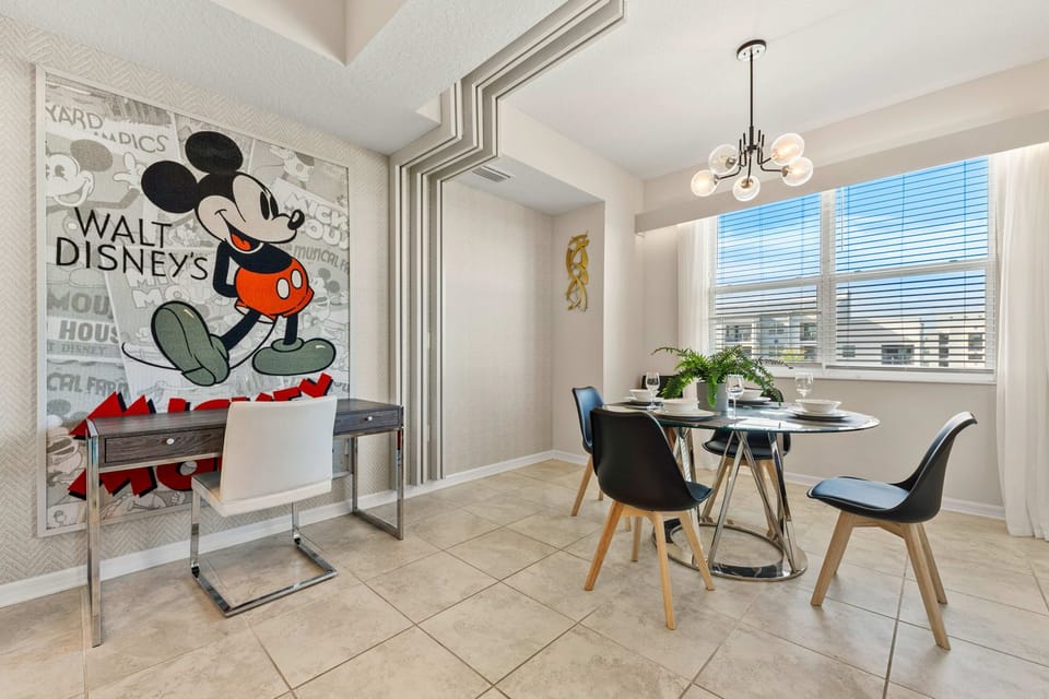 Alluring dining area of the condo in Kissimmee Florida - Artfully arranged table settings for a touch of elegance - Dining for 4 persons with an additional chair - Functional and aesthetically pleasing space