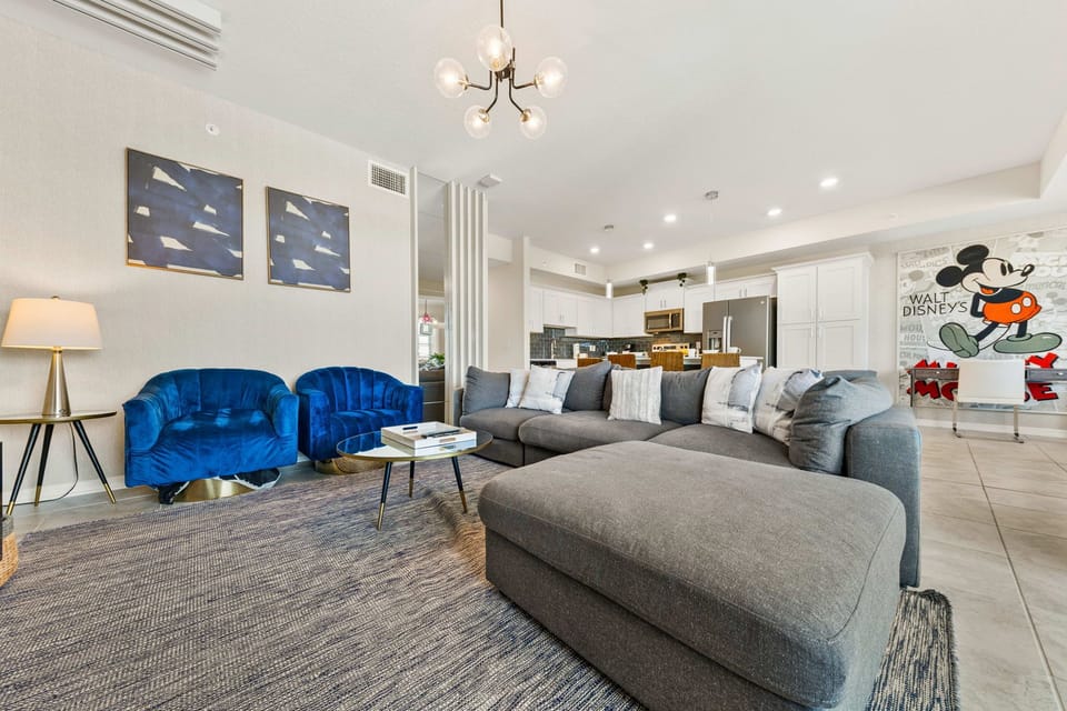 Charming living area of the condo in Kissimmee Florida - Transforms with a Smart TV, offering cinematic bliss and cozy gatherings - Thoughtful mix of textures, from plush rugs to tasteful throw pillows - Comfy sofas and inviting ambiance
