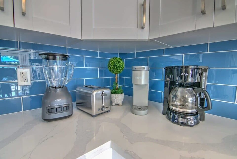 The Kitchen Includes Small Electronic Gadgets Including a Regular and Keurig Coffee Maker, a Blender and a Toaster