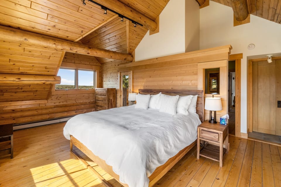 Master bedroom with king sized bed and en suite bathroom.