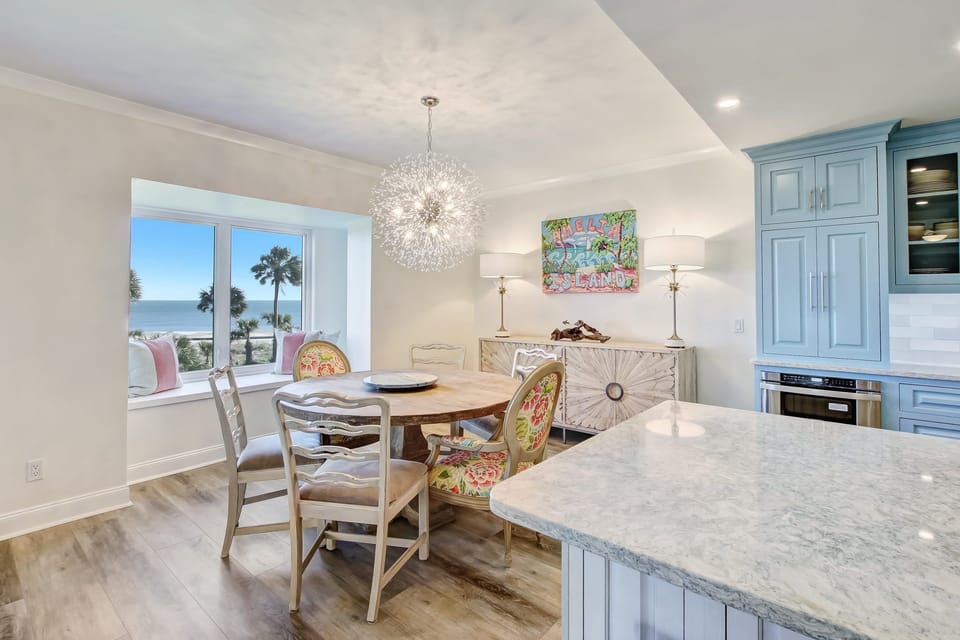 Wooden Dining Table with Seating for 6 Centered on a Bay Window with Gorgeous Ocean Views