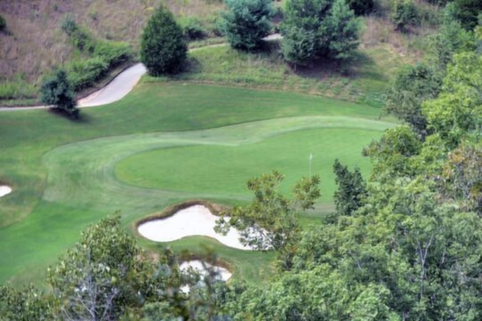 Scenic view of the golf course surrounded by lush greenery.