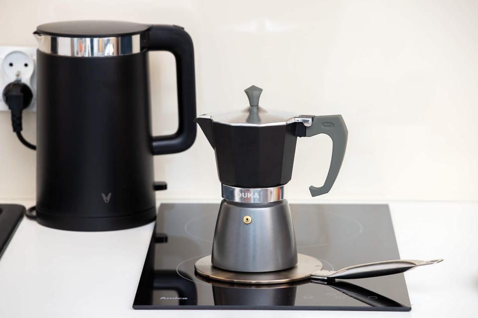 A close-up of a coffee maker and accessories, ideal for a fresh start to the day.