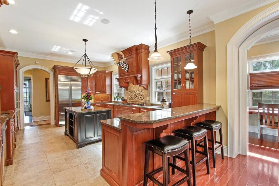 Massive Gourmet Chef Kitchen with High End Wolf Appliances, Double Stove, Wine Refrigerator & More - Perfect for the Whole Family to Make a Meal!