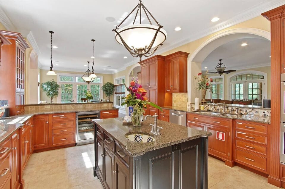 Massive Gourmet Chef Kitchen with High End Wolf Appliances, Double Stove, Wine Refrigerator & More - Perfect for the Whole Family to Make a Meal!