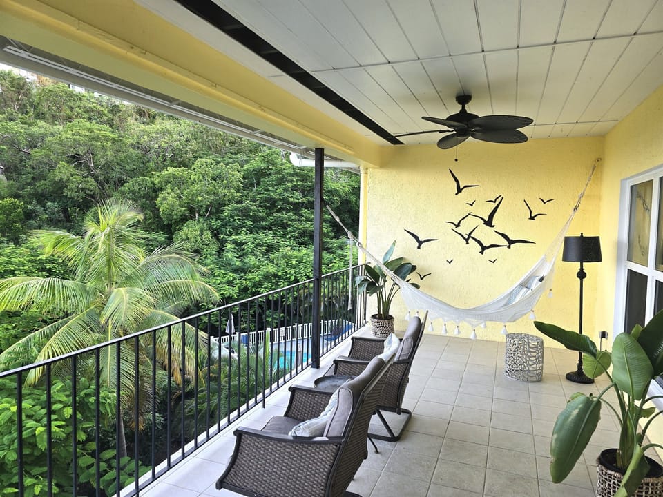 Luxurious hammock and comfy club rockers for enjoying the views