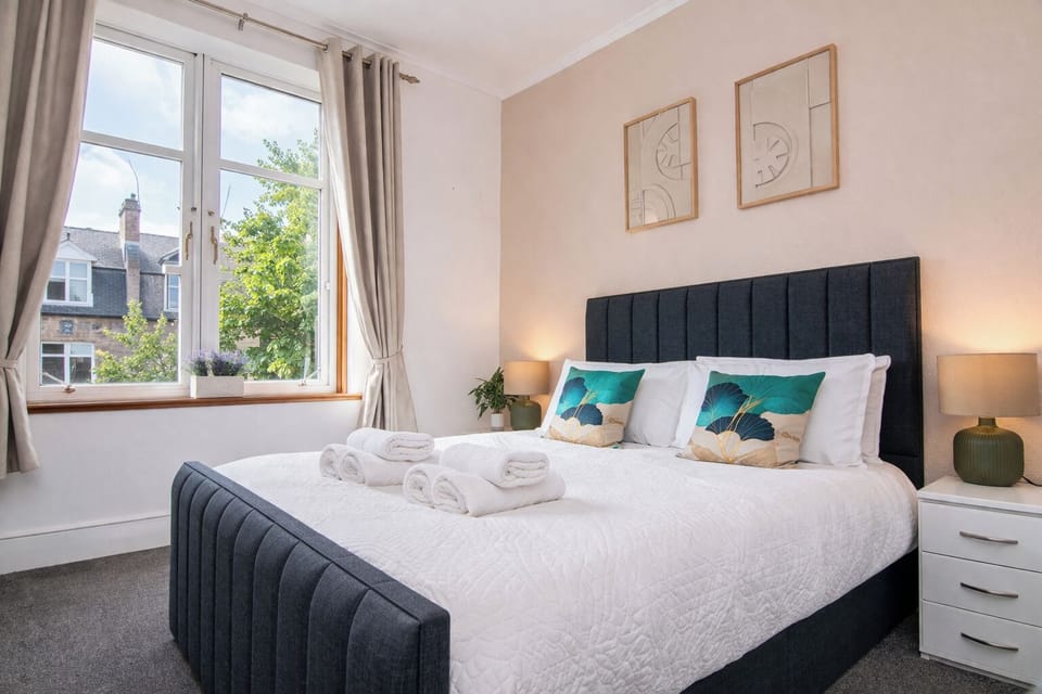 Spacious bedroom with full mirrored wardrobes and natural light. Ample storage for longer stays, relocations, or corporate bookings — plus blackout curtains for uninterrupted sleep.