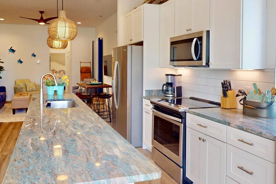 Enjoy the stunning counter tops and huge island in this modern kitchen