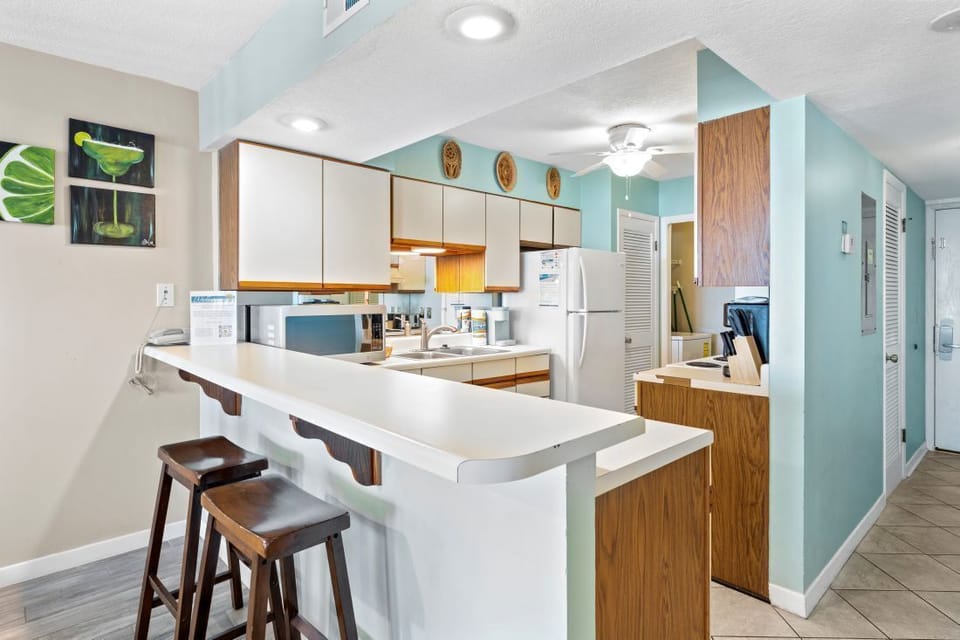 Your open kitchen with breakfast bar creates the perfect space for morning coffee and casual meals together.