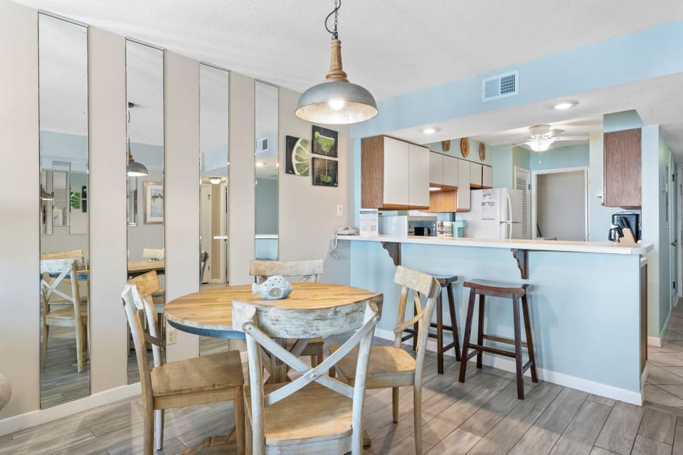 Step into your bright open kitchen and dining area, where coastal charm meets modern comfort for memorable meals together.