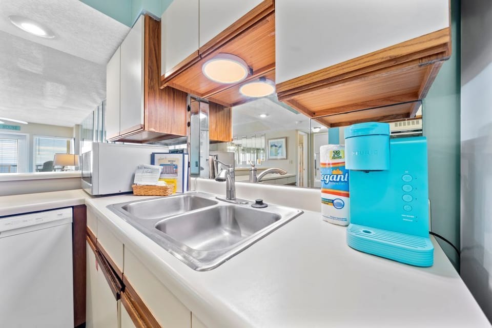 Step into your well-equipped kitchen featuring warm wood accents, modern appliances, and thoughtful touches that make cooking feel like home.