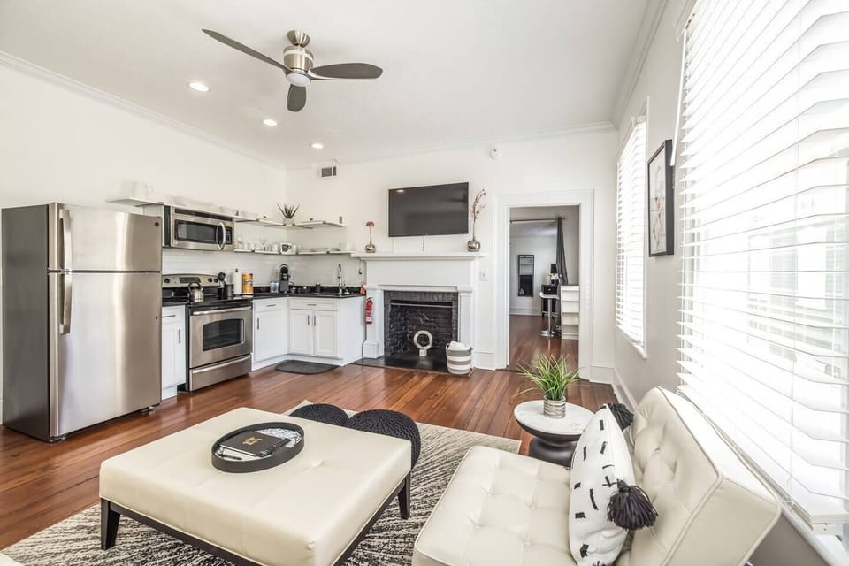 The remodeled kitchen, high ceilings and open floor plan, give the living room/kitchen a wonderful homey feel you'll just love. Through that doorway is the full bath and bedroom. 