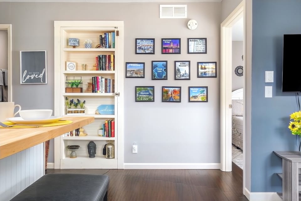 The book shelf is on wheels & opens to the main side of the home. 