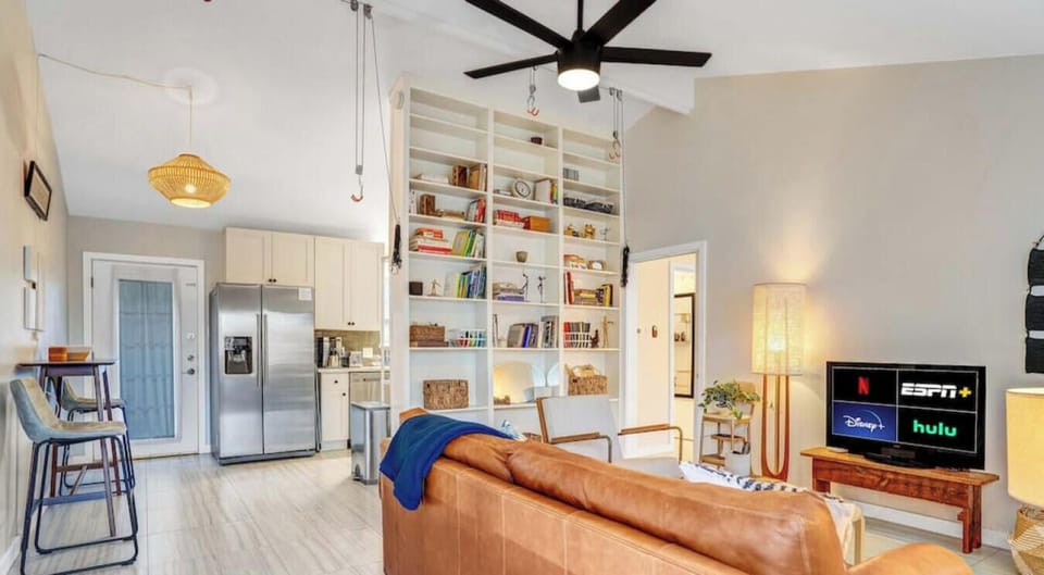 Living room with sleeper sofa, TV, full bookshelf and bike hooks!