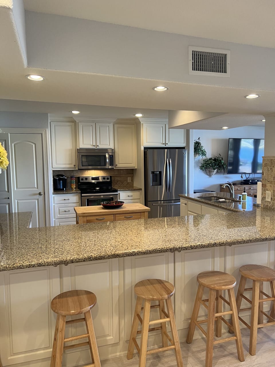 1st floor fully stocked kitchen with extra seating around the counters.
