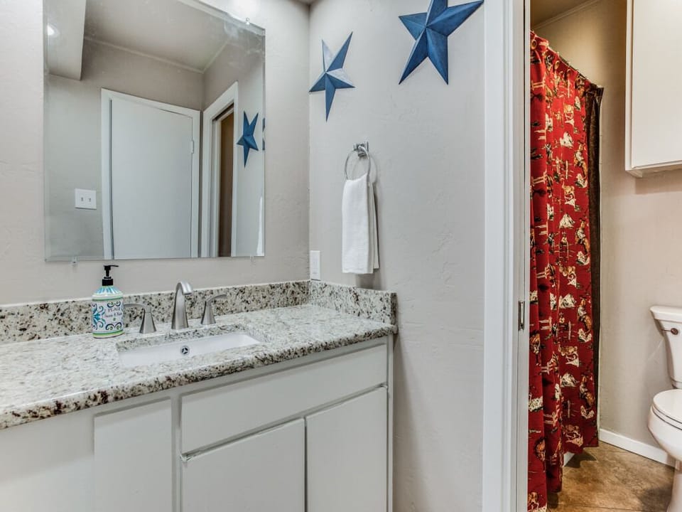 Hall bathroom with separated vanity & commode area.
