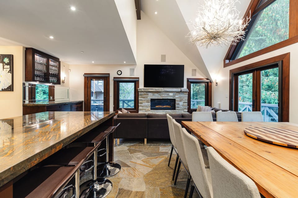 Main level open-plan living / dining / kitchen with fireplace