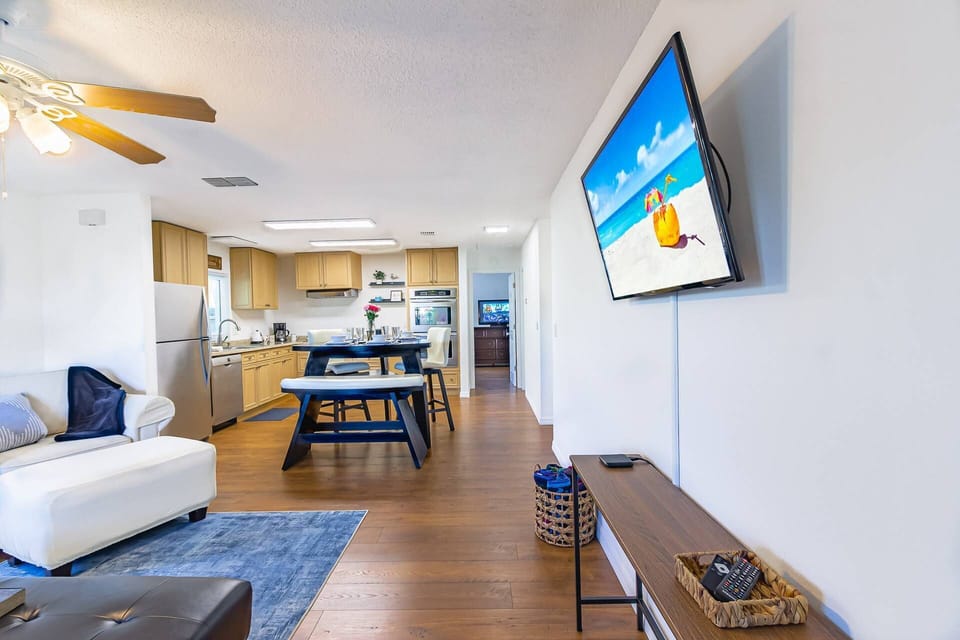 From the entryway (keyless entry) in to the living room with wall-mounted Smart TV for streaming Apps.