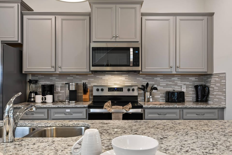 Modern Style Downstairs Area with Kitchen and Barstool Seating