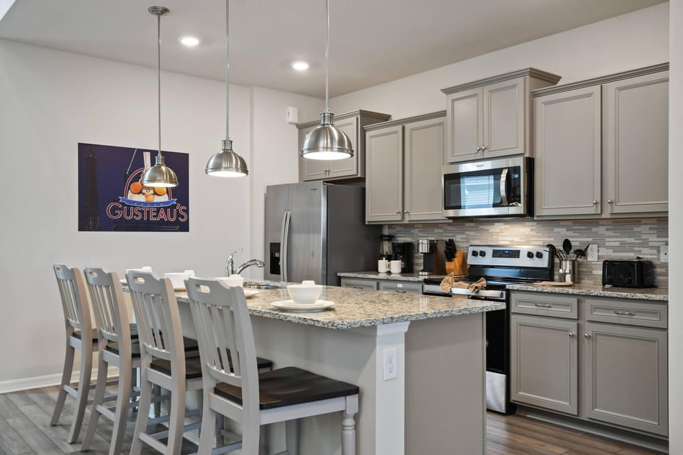 Modern Style Downstairs Area with Kitchen and Barstool Seating